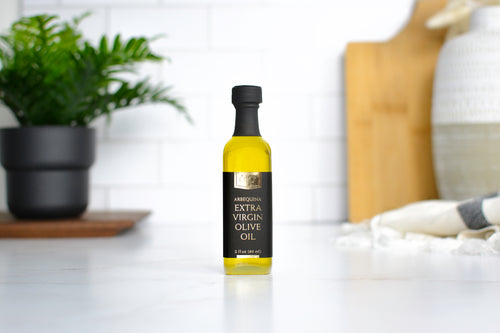 Black & Gold Arbequina Extra Virgin Olive Oil in a glass bottle with a black and gold label
