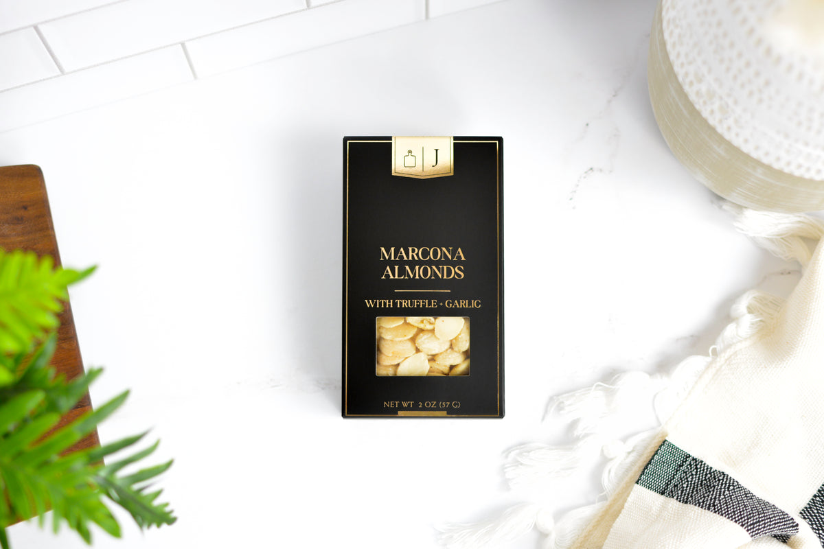 Black & Gold Marcona Almonds with truffle and garlic in a black box with gold lettering
