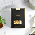 Black & Gold Water Crackers box with gold lettering and a clear cracker window