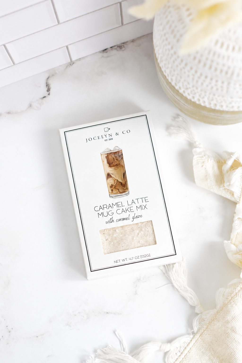 Jocelyn & Co. Caramel Latte Mug Cake Mix box on a pale marble countertop
