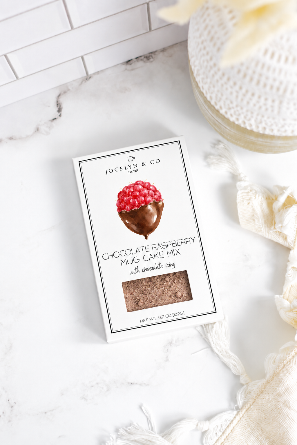 Jocelyn & Co. Chocolate Raspberry Mug Cake Mix box on a pale marble countertop