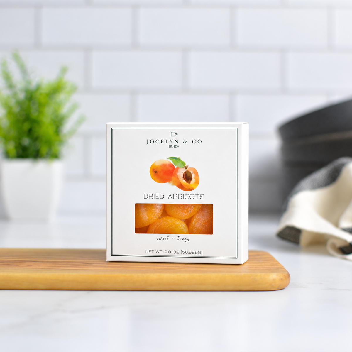 Jocelyn & Co. Dried Apricots, upright on a wooden board in a softly lit kitchen setting