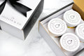 Jocelyn & Co. Fruit & Nuts Gift Box with four white-lidded jars beside its ribbon-tied lid