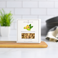 Jocelyn & Co. Roasted Pistachios, upright on a wooden board in a softly lit kitchen setting