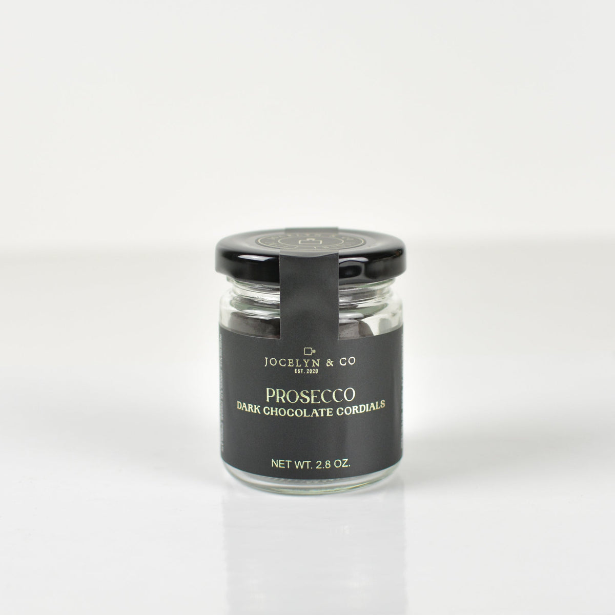 Jocelyn & Co. Prosecco Cordials, in a black-lidded jar against a light background