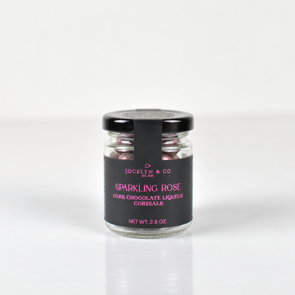 Jocelyn & Co. Sparkling Rose Cordials, in a black-lidded jar against a light background