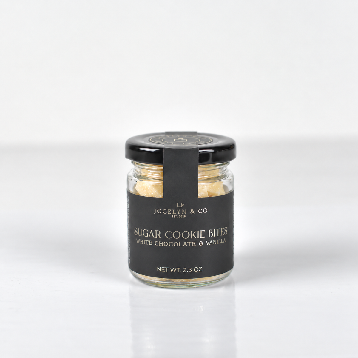 Jocelyn & Co. Sugar Cookie Bites jar on a softly lit pale background