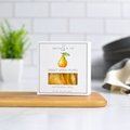 Jocelyn & Co. Sweet Dried Pears, upright on a wooden board in a softly lit kitchen setting