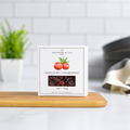 Jocelyn & Co. Sweetened Cranberries, upright on a wooden board in a softly lit kitchen setting