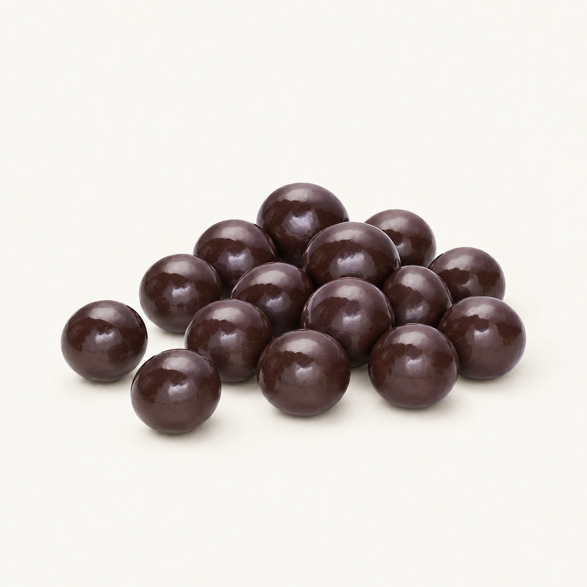 Dark chocolate Blackberry Brandy Cordials in a small pile on warm ivory