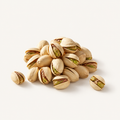 Pistachios, styled as a small pile on warm ivory