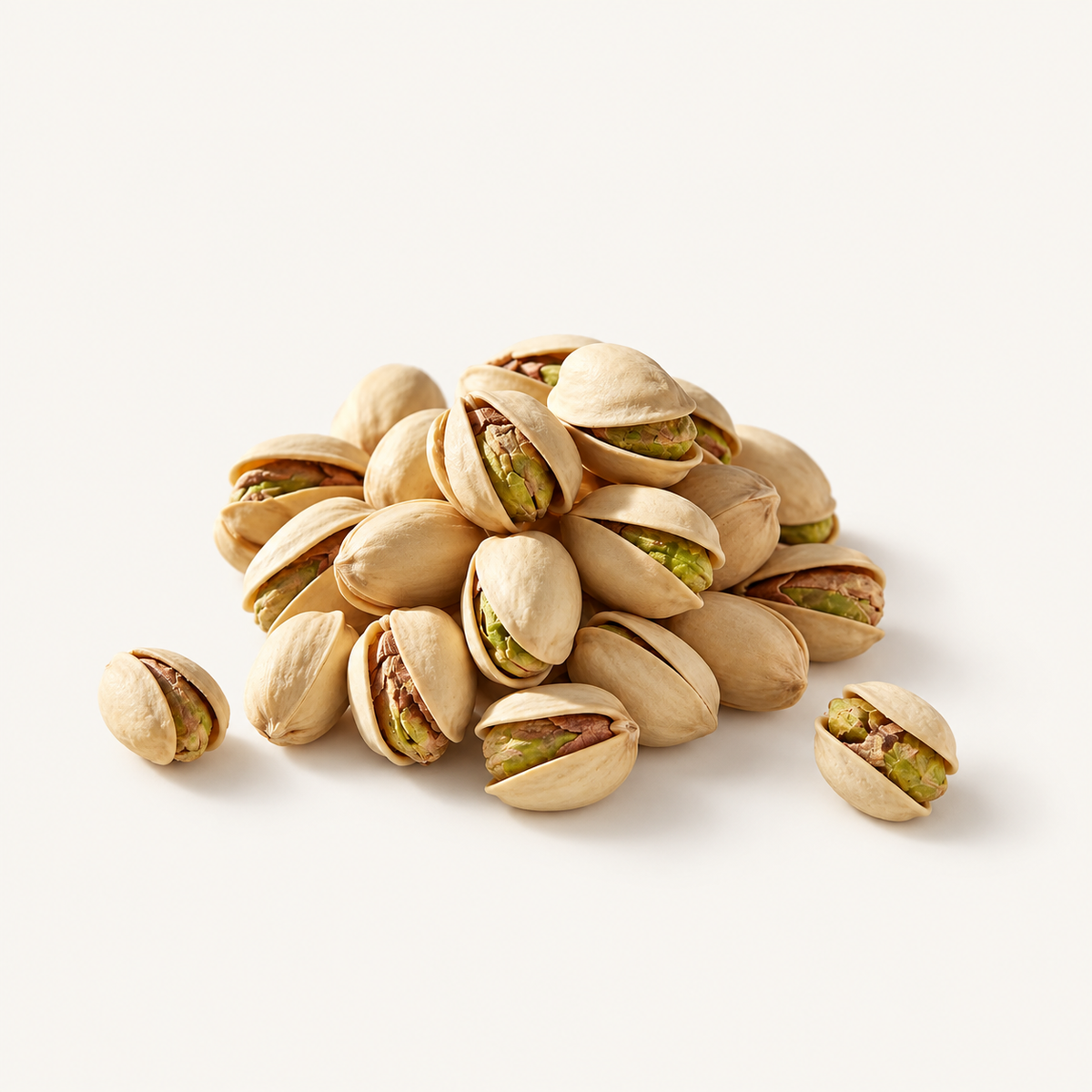 Pistachios, styled as a small pile on warm ivory