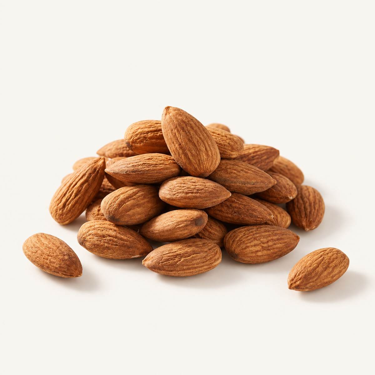 Raw Almonds, styled as a small pile on warm ivory